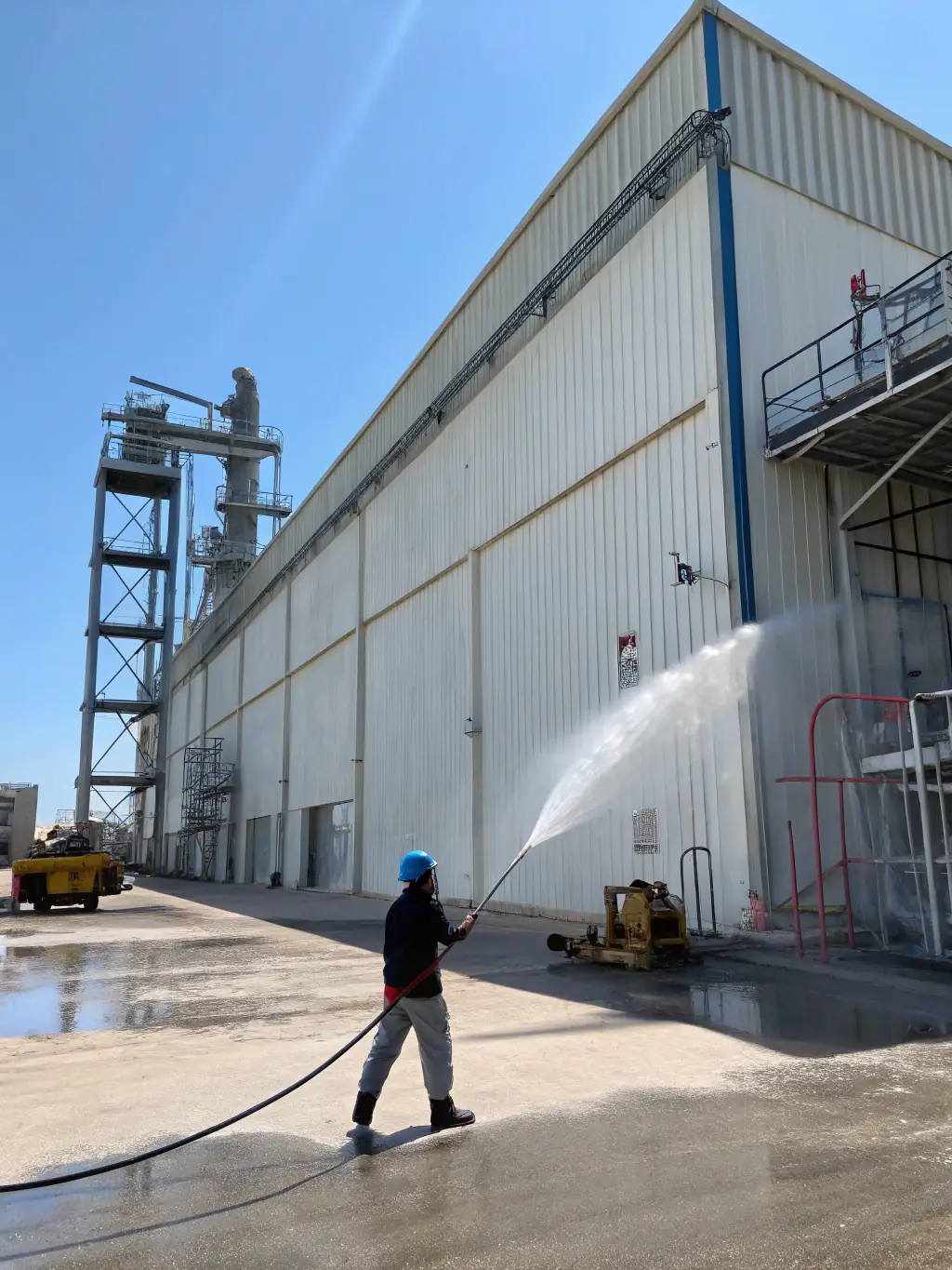 A commercial building facade being power washed by Xpress Wash Solutions, highlighting the clean and refreshed look.
